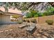 Inviting backyard with rock landscaping, lounge chairs, and privacy wall at 41229 N Belfair Way, Anthem, AZ 85086