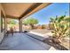 Covered patio in a desert landscape with natural vegetation, gravel and a seating area at 41229 N Belfair Way, Anthem, AZ 85086