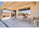 Covered patio with lounge seating and outdoor grill, seamlessly merging indoor-outdoor living at 41229 N Belfair Way, Anthem, AZ 85086