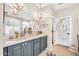 Elegant bathroom with double vanity, chandeliers, and walk-in closet at 41229 N Belfair Way, Anthem, AZ 85086