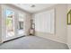 Bright bedroom with french doors, plantation shutters, and a neutral color palette at 41229 N Belfair Way, Anthem, AZ 85086