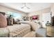 Spacious bedroom with ceiling fan, scenic window views, and comfortable furnishings at 41229 N Belfair Way, Anthem, AZ 85086