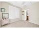 Bedroom with a vintage cabinet, shuttered windows, and ensuite bathroom access at 41229 N Belfair Way, Anthem, AZ 85086