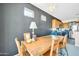 Dining room with rustic wooden table, dark accent wall, and modern chandelier at 41229 N Belfair Way, Anthem, AZ 85086