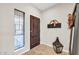 Welcoming entryway featuring a dark wood door, window with blinds, and decorative lantern at 41229 N Belfair Way, Anthem, AZ 85086