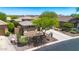 Beautiful aerial view of a home with desert landscaping and a spacious driveway at 41229 N Belfair Way, Anthem, AZ 85086