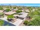 Stunning view of a luxurious desert home nestled among lush greenery and desert landscaping at 41229 N Belfair Way, Anthem, AZ 85086