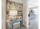 Hallway view with rustic wood door decor, leading to a bright and airy room with a stylish accent cabinet at 41229 N Belfair Way, Anthem, AZ 85086