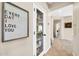 Hallway view with decor and a glass-front cabinet providing storage for dishware and household items at 41229 N Belfair Way, Anthem, AZ 85086