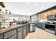 Well-equipped kitchen with stainless steel appliances, granite countertops, and tile floors at 41229 N Belfair Way, Anthem, AZ 85086