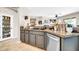 Charming kitchenette with granite countertops, a black sink, gray cabinets and stainless steel dishwasher at 41229 N Belfair Way, Anthem, AZ 85086