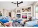Inviting living room showcasing a cozy fireplace, stylish decor, and comfortable seating at 41229 N Belfair Way, Anthem, AZ 85086