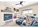 Cozy living room with fireplace, built-in shelves, and lots of natural light at 41229 N Belfair Way, Anthem, AZ 85086