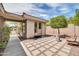 Private outdoor patio with decorative stone tile, potted tree, and seating at 41229 N Belfair Way, Anthem, AZ 85086
