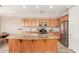 Spacious kitchen featuring a large island with granite countertop, stainless steel appliances and light wood cabinets at 41906 N Crooked Stick Rd, Anthem, AZ 85086