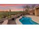 Tranquil pool area with desert views, complemented by desert landscaping at 41906 N Crooked Stick Rd, Anthem, AZ 85086