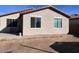 Backyard view showcases the exterior of the house with a neat lawn and charming windows at 4250 N 87Th Ln, Phoenix, AZ 85037