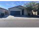 Charming single-story home with a well-maintained lawn and two car garage at 4250 N 87Th Ln, Phoenix, AZ 85037