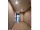 Hallway with neutral paint and tile flooring at 4250 N 87Th Ln, Phoenix, AZ 85037