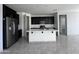 Modern kitchen with stainless steel refrigerator and a center island at 4250 N 87Th Ln, Phoenix, AZ 85037