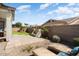 Expansive backyard with a stone water feature, patio, and lush landscaping provides a private outdoor retreat at 4683 N 206Th Ln, Buckeye, AZ 85396