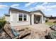 Inviting backyard with lounge chairs, covered patio, and manicured landscaping offers a perfect outdoor oasis at 4683 N 206Th Ln, Buckeye, AZ 85396