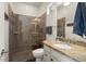 Bathroom with tiled shower and vanity with granite countertop at 4683 N 206Th Ln, Buckeye, AZ 85396