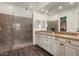 Bathroom featuring glass shower, double sink vanity, and modern fixtures at 4683 N 206Th Ln, Buckeye, AZ 85396
