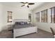 Bedroom featuring neutral colors, ceiling fan, and multiple windows for natural light at 4683 N 206Th Ln, Buckeye, AZ 85396