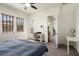 Bedroom featuring neutral colors, ceiling fan, and large windows with wooden blinds at 4683 N 206Th Ln, Buckeye, AZ 85396