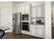 Modern kitchen featuring stainless steel appliances, white cabinets, and granite countertops at 4683 N 206Th Ln, Buckeye, AZ 85396