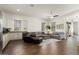 Open floor plan with stylish living area next to the kitchen, wood-look flooring and neutral decor at 4683 N 206Th Ln, Buckeye, AZ 85396