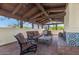 Upper level terrace with an outdoor fireplace, comfortable seating, and scenic views of the surrounding landscape at 4726 E Sierra Vista Dr, Paradise Valley, AZ 85253