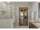 Bathroom featuring a glass shower, ceramic tile, and wooden door to patio at 4726 E Sierra Vista Dr, Paradise Valley, AZ 85253