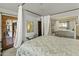 Bedroom featuring a four poster bed and mirrored sliding door closet at 4726 E Sierra Vista Dr, Paradise Valley, AZ 85253