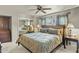Comfortable bedroom featuring a large bed, a mirrored closet door, and a ceiling fan at 4726 E Sierra Vista Dr, Paradise Valley, AZ 85253