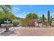 Landscaped courtyard featuring a decorative fountain, mature trees, and vibrant flowering bushes at 4726 E Sierra Vista Dr, Paradise Valley, AZ 85253