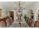 A decorative chandelier hangs over a glass dining table with seating, providing an intimate setting at 4726 E Sierra Vista Dr, Paradise Valley, AZ 85253