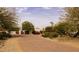 Long brick driveway leads to a beautifully landscaped property, enhanced by mature trees and vibrant bougainvillea at 4726 E Sierra Vista Dr, Paradise Valley, AZ 85253