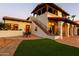 Elegant stucco home with red tile roof, outdoor seating, iron stair railing and lush green lawn at 4726 E Sierra Vista Dr, Paradise Valley, AZ 85253