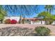 Charming home exterior with a white wall, decorative cacti, and colorful bougainvillea at 4726 E Sierra Vista Dr, Paradise Valley, AZ 85253