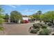 Charming desert home featuring mature landscaping, paved drive, and a backdrop of majestic mountains in the distance at 4726 E Sierra Vista Dr, Paradise Valley, AZ 85253