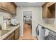 Convenient laundry room with granite countertops, built-in cabinets, and a doorway leading to the kitchen at 4726 E Sierra Vista Dr, Paradise Valley, AZ 85253