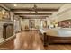 Spacious main bedroom with exposed wood beams, decorative fireplace, and French doors to the exterior at 4726 E Sierra Vista Dr, Paradise Valley, AZ 85253