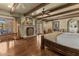 Expansive main bedroom boasts a stone fireplace, wood floors, exposed beams, and French door access at 4726 E Sierra Vista Dr, Paradise Valley, AZ 85253