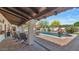 Relaxing covered patio with comfortable seating overlooking a refreshing pool and lush backyard at 4726 E Sierra Vista Dr, Paradise Valley, AZ 85253