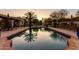 Relaxing pool reflecting palm trees, with outdoor seating, and lush landscaping at 4726 E Sierra Vista Dr, Paradise Valley, AZ 85253