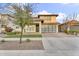 Attractive two-story home featuring a modern aesthetic, tidy landscaping, and a distinctive glass garage door at 4741 S Avitus Ln, Mesa, AZ 85212