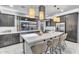 Spacious kitchen island with seating and sleek cabinets, with a view of the backyard at 4741 S Avitus Ln, Mesa, AZ 85212