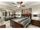Modern bedroom with a queen bed, mirrored closet, ceiling fan, and two nightstands at 4850 E Desert Cove Ave # 227, Scottsdale, AZ 85254